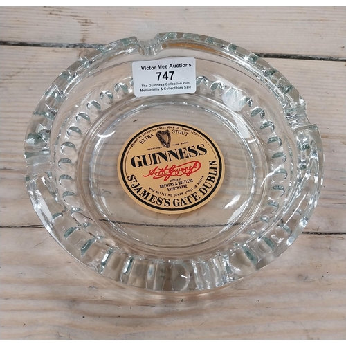 747 - Clear Glass Guinness ashtray with Guinness Dublin label. Ravenhead Glass {4 cm H x 15 cm Dia.}. PART... 