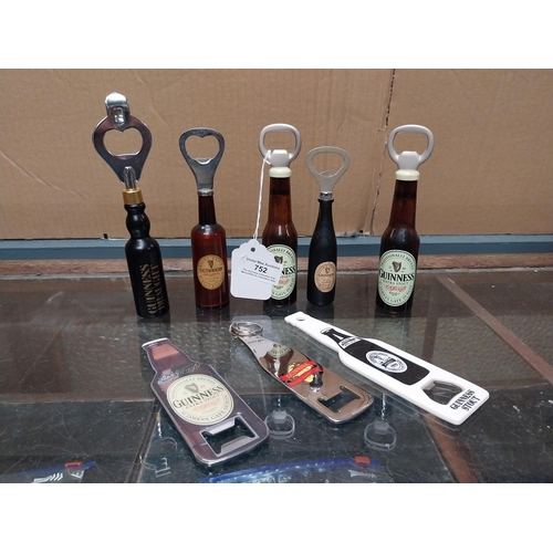 752 - Guinness Bottle openers in shape of Guinness Bottles (one white plastic with bottle printed in black... 