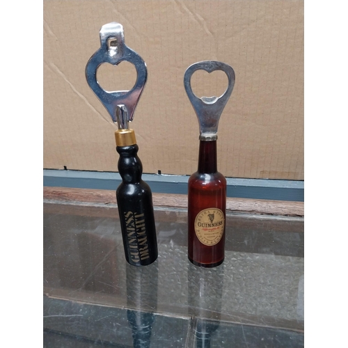 752 - Guinness Bottle openers in shape of Guinness Bottles (one white plastic with bottle printed in black... 