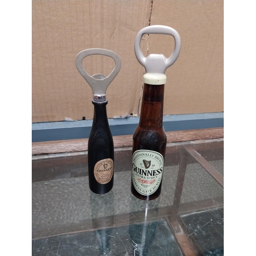 752 - Guinness Bottle openers in shape of Guinness Bottles (one white plastic with bottle printed in black... 