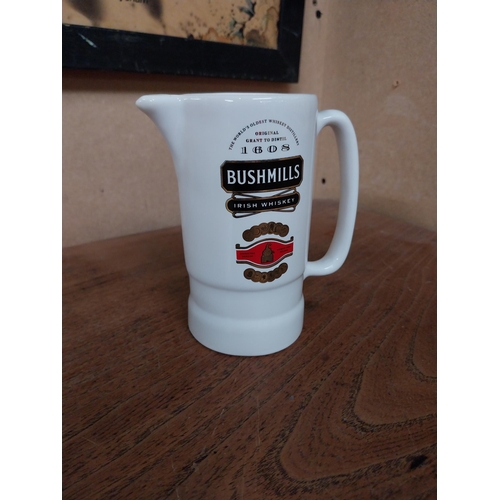 81 - Cowans Old Irish Whiskey ceramic advertising jug {13 cm H x 29 cm W} and Bushmills Whiskey ceramic a... 