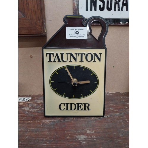 82 - Taunton Cider Perspex battery advertising clock. {19 cm H x 12 cm W}.