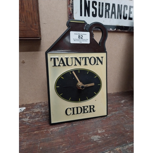 82 - Taunton Cider Perspex battery advertising clock. {19 cm H x 12 cm W}.