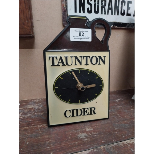 82 - Taunton Cider Perspex battery advertising clock. {19 cm H x 12 cm W}.