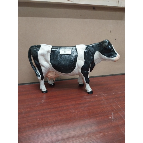 831 - Cast iron model of Freisian Cow. {20 cm H x 33 cm W x 9 cm D}.