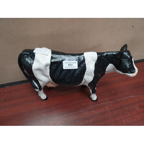 831 - Cast iron model of Freisian Cow. {20 cm H x 33 cm W x 9 cm D}.