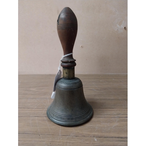 913 - Victorian brass pub bell with wooden handle. {23 cm H x 12 cm Dia.}.