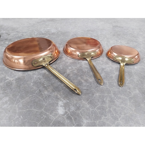 930 - Set of graduated copper and brass pans. {5 cm H x 25 cm Dia to 3 cm H x 15 cm Dia.}.