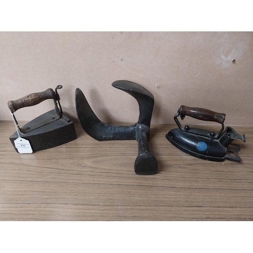 936 - Shoe last {20 cm H 17 cm H}  and two metal irons {15 cm H}.