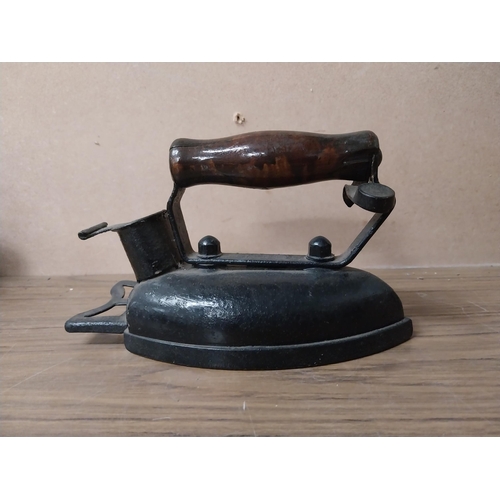 936 - Shoe last {20 cm H 17 cm H}  and two metal irons {15 cm H}.