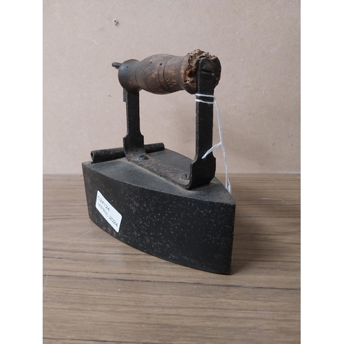 936 - Shoe last {20 cm H 17 cm H}  and two metal irons {15 cm H}.