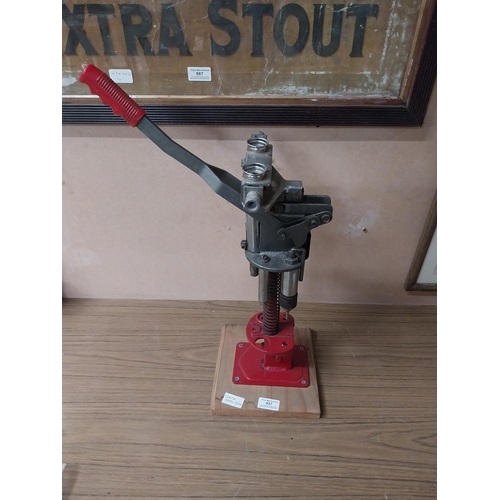 937 - 20th C. metal puncher on wooden plinth. {45 cm H x 21 cm W x 21 cm D}.