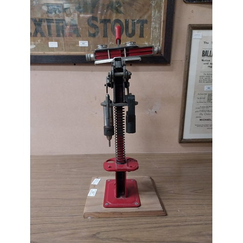 937 - 20th C. metal puncher on wooden plinth. {45 cm H x 21 cm W x 21 cm D}.