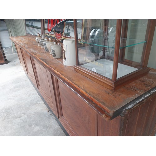 450A - Early 20th C. mahogany and pine bar counter with four inset panels {104 cm H x 410 cm W x 65 cm D}.