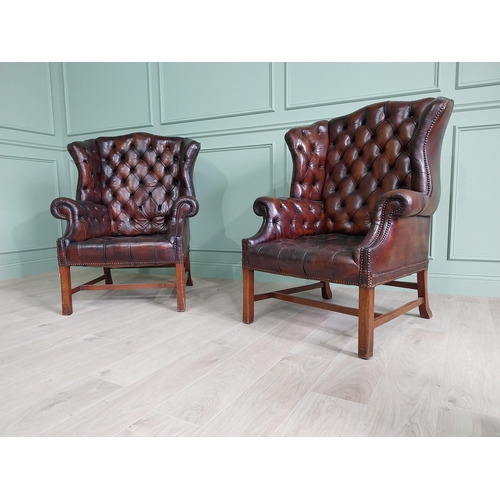 100 - Pair of good quality early 20th C. hand died cigar leather deep buttoned wing back chairs raised on ... 