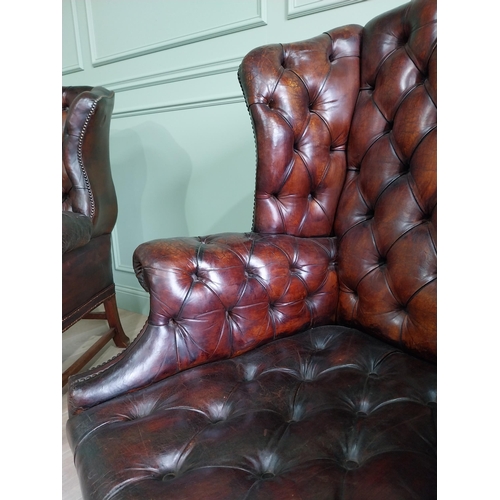 100 - Pair of good quality early 20th C. hand died cigar leather deep buttoned wing back chairs raised on ... 