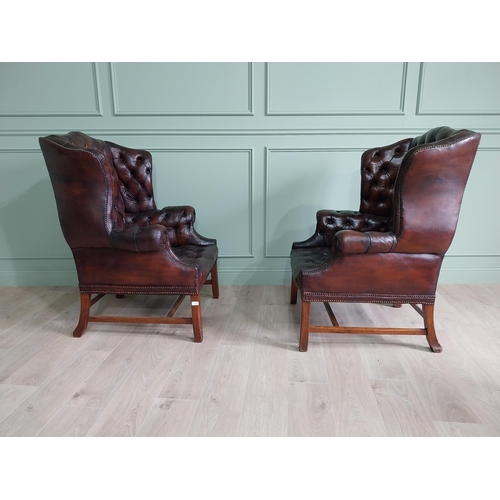 100 - Pair of good quality early 20th C. hand died cigar leather deep buttoned wing back chairs raised on ... 