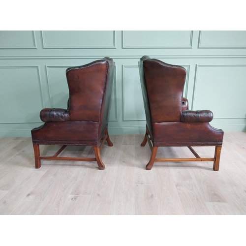 100 - Pair of good quality early 20th C. hand died cigar leather deep buttoned wing back chairs raised on ... 