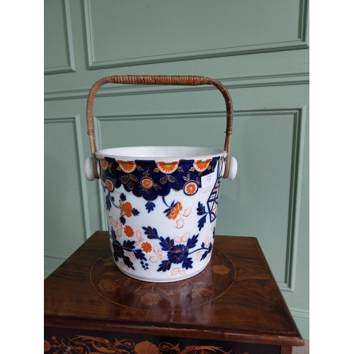 113 - 19th C. ceramic pot with wicker handle. {37 cm H x 32 cm W x 26 cm D}.