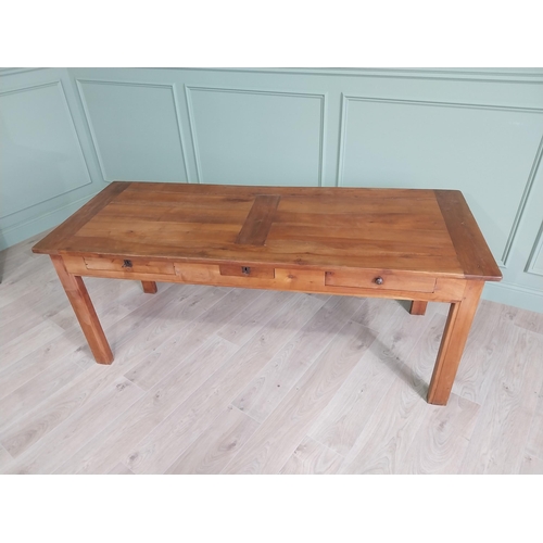 114 - Good quality early 20th C. cherrywood kitchen table with three drawers in the frieze raised on squar... 