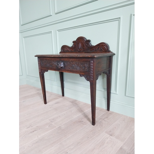 133 - 19th C. carved oak side table with decorative gallery back and single drawer in the frieze raised on... 