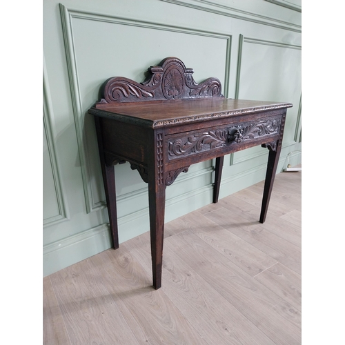 133 - 19th C. carved oak side table with decorative gallery back and single drawer in the frieze raised on... 