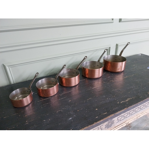 143 - Set of five French copper saucepans {20 cm H x 39 cm W x 20 cm D and 13 cm H x 22 cm W x 12 cm D}.