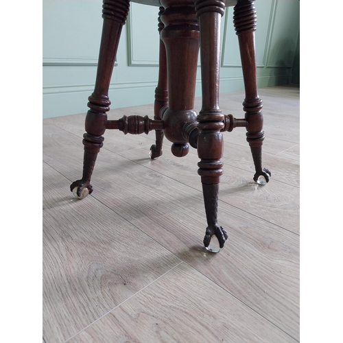 175 - Edwardian mahogany revolving stool with upholstered seat raised on turned legs and ball & claw feet ... 