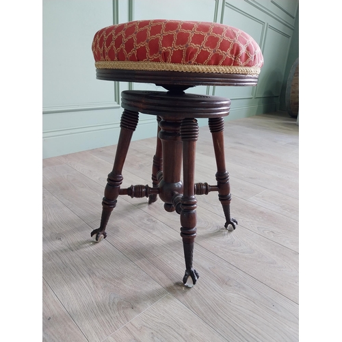 175 - Edwardian mahogany revolving stool with upholstered seat raised on turned legs and ball & claw feet ... 