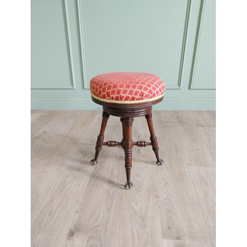 175 - Edwardian mahogany revolving stool with upholstered seat raised on turned legs and ball & claw feet ... 