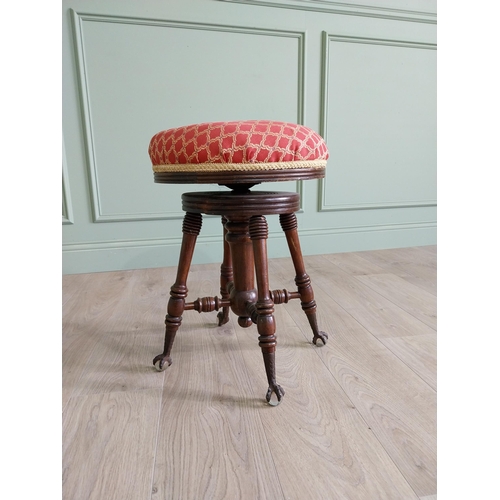 175 - Edwardian mahogany revolving stool with upholstered seat raised on turned legs and ball & claw feet ... 