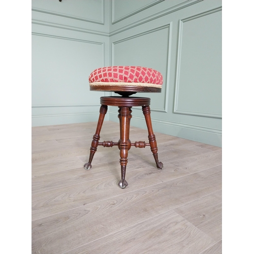 175 - Edwardian mahogany revolving stool with upholstered seat raised on turned legs and ball & claw feet ... 