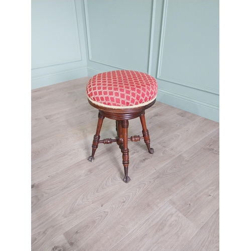 175 - Edwardian mahogany revolving stool with upholstered seat raised on turned legs and ball & claw feet ... 