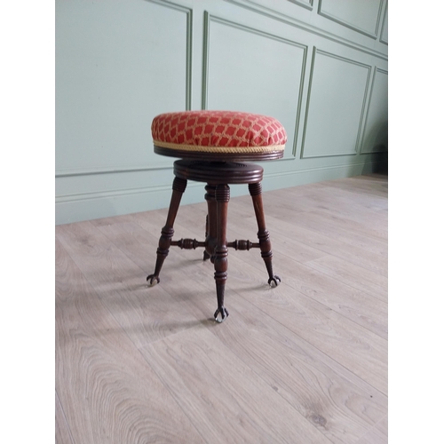 175 - Edwardian mahogany revolving stool with upholstered seat raised on turned legs and ball & claw feet ... 