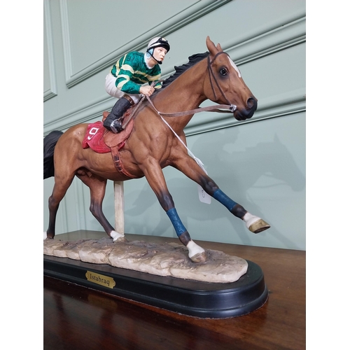 177 - Hand painted ceramic statuette of Istabraq horse and his jockey {34 cm H x 50 cm W x 12 cm D}.