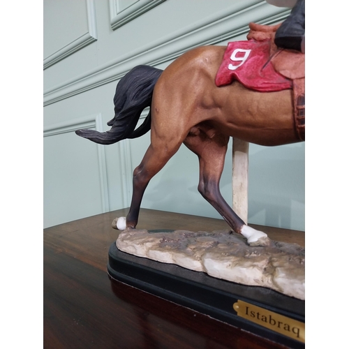 177 - Hand painted ceramic statuette of Istabraq horse and his jockey {34 cm H x 50 cm W x 12 cm D}.