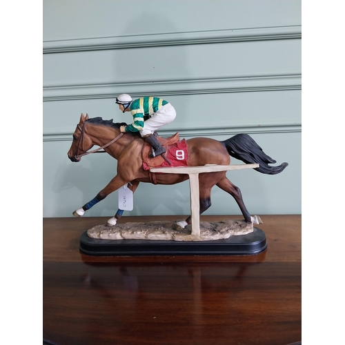 177 - Hand painted ceramic statuette of Istabraq horse and his jockey {34 cm H x 50 cm W x 12 cm D}.