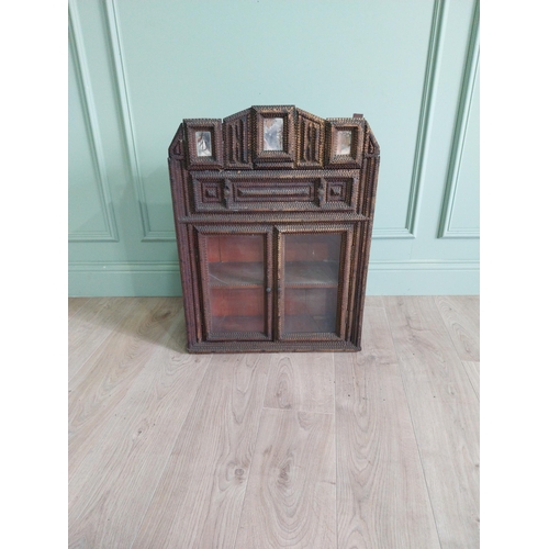 21 - Early 20th C. tramp art wall hanging cabinet with two glazed doors {70 cm H x 54 cm W x 23 cm D}.