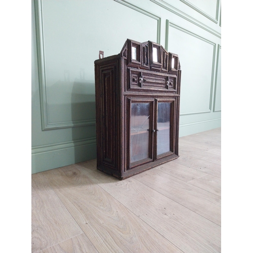 21 - Early 20th C. tramp art wall hanging cabinet with two glazed doors {70 cm H x 54 cm W x 23 cm D}.