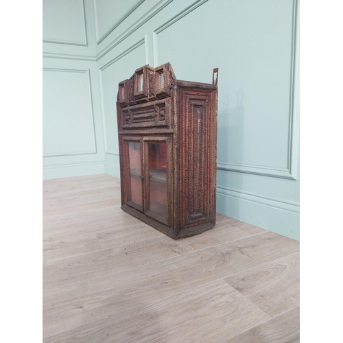 21 - Early 20th C. tramp art wall hanging cabinet with two glazed doors {70 cm H x 54 cm W x 23 cm D}.