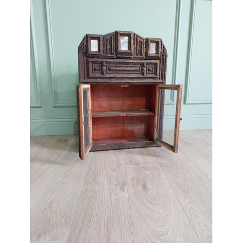 21 - Early 20th C. tramp art wall hanging cabinet with two glazed doors {70 cm H x 54 cm W x 23 cm D}.