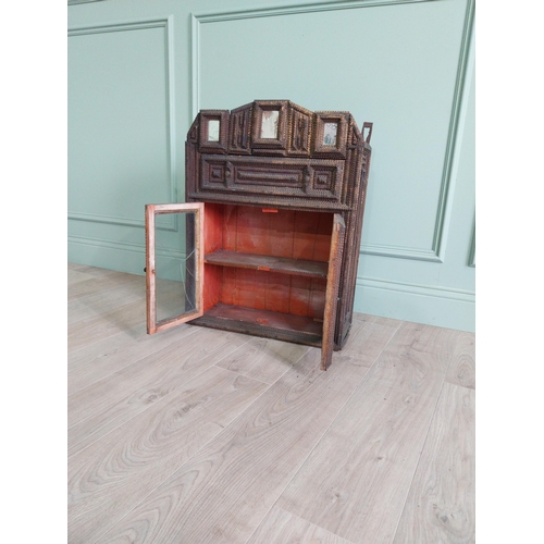 21 - Early 20th C. tramp art wall hanging cabinet with two glazed doors {70 cm H x 54 cm W x 23 cm D}.