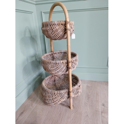 216 - Good quality three tier wicker vegetable rack. {110 cm H x 55 cm W x 50 cm D}.