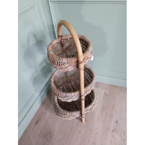 216 - Good quality three tier wicker vegetable rack. {110 cm H x 55 cm W x 50 cm D}.