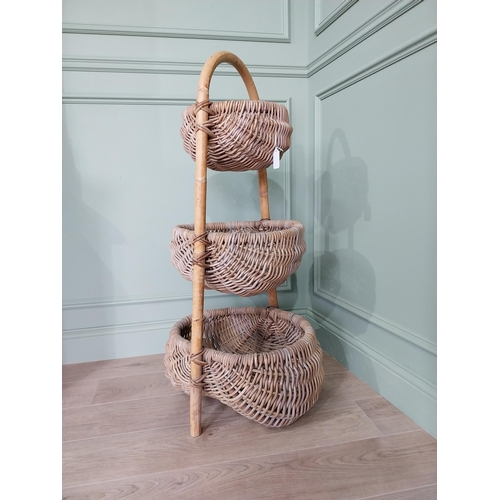 216 - Good quality three tier wicker vegetable rack. {110 cm H x 55 cm W x 50 cm D}.