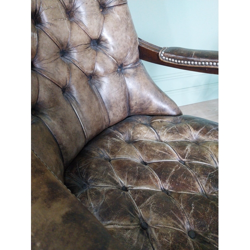 217 - Pair of good quality deep buttoned leather upholstered library chairs on turned tapered legs. {108 c... 