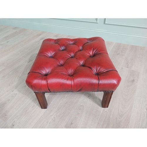 226 - Ox-blood leather deep buttoned upholstered foot stool raised on square mahogany legs and single stre... 