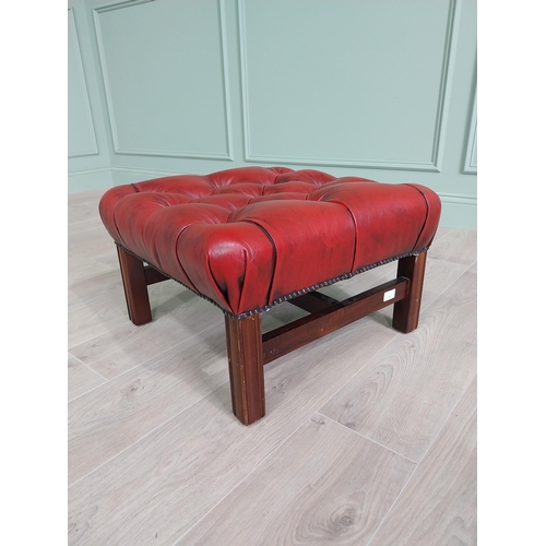 226 - Ox-blood leather deep buttoned upholstered foot stool raised on square mahogany legs and single stre... 