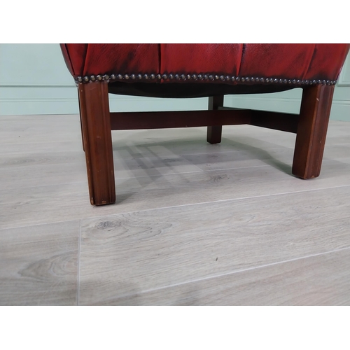 226 - Ox-blood leather deep buttoned upholstered foot stool raised on square mahogany legs and single stre... 