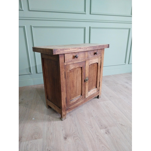 268 - Early 20th C. oak and pine cupboard with two long doors over two short drawers on square feet. {80 c... 